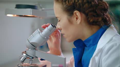 Female-scientist-looking-microscope.-Close-up-of-scientist-microscope